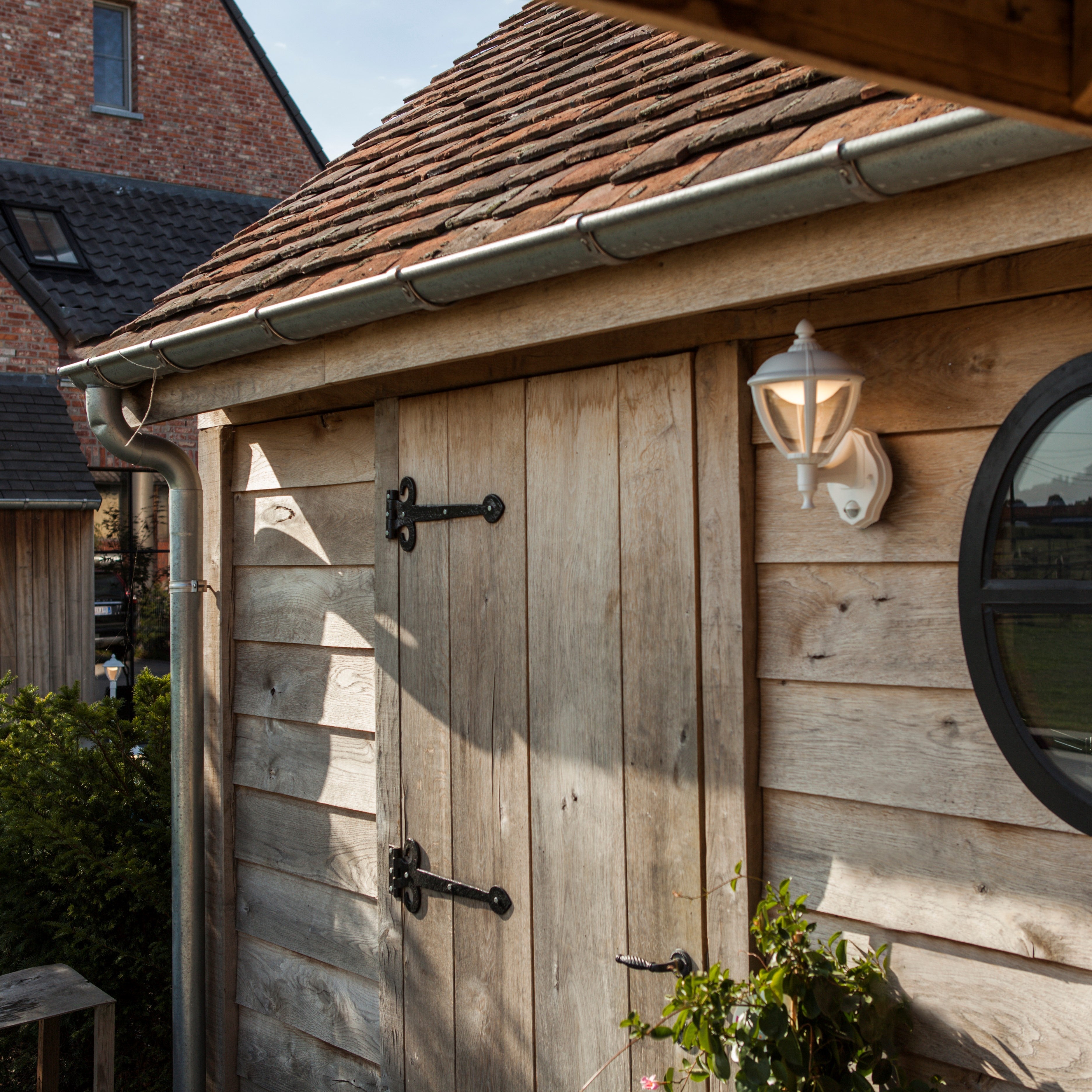 Lutec Unite PIR Integrated LED Outdoor Wall Light - White 5260103030 fixed to an shed