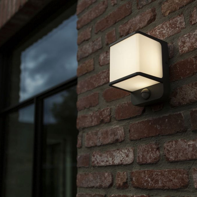 Square outdoor wall light fixture on a brick wall