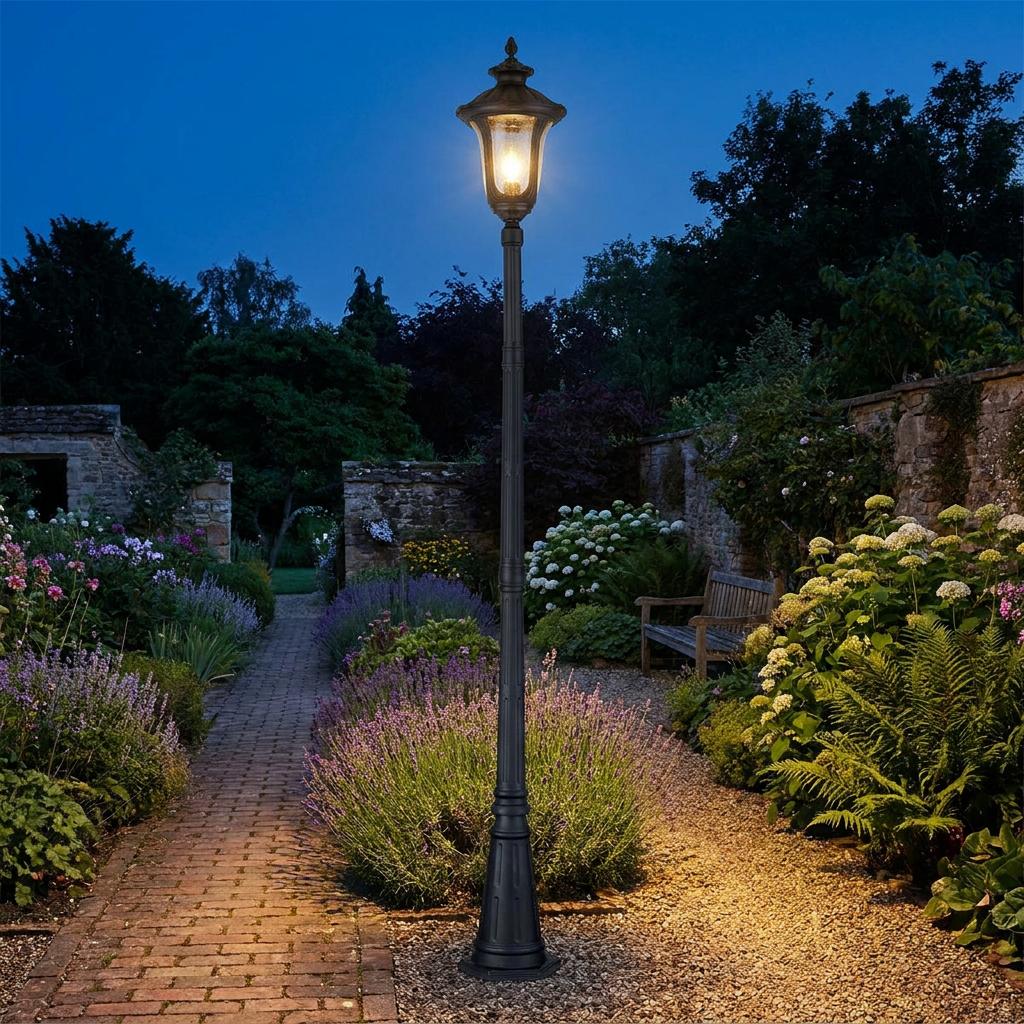An Elstead Chicago 1 Light Single Outdoor Lamp Post illuminates a garden path at dusk.