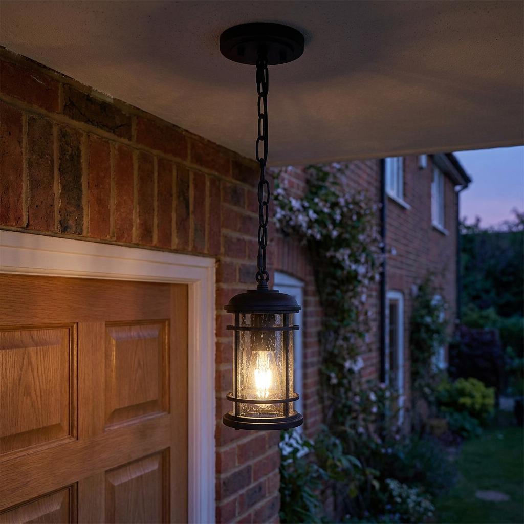 Feiss Lighthouse outdoor chain lantern with seeded glass and black finish hanging from a porch ceiling.