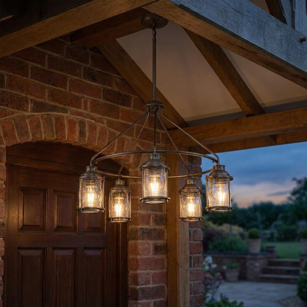 Kichler Ashland Bay 5-light outdoor chandelier with seeded glass shades hanging from a rustic wooden porch ceiling.
